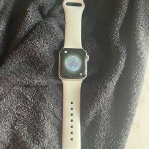 Apple 4 40mm watch with white band, wall charger and charger cord for watches.
